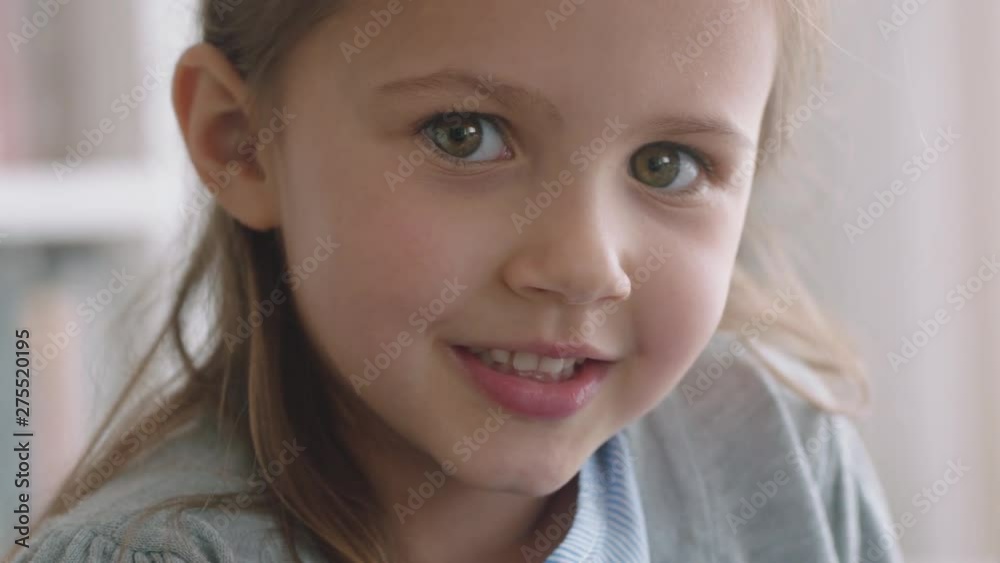 portrait beautiful little girl smiling with natural childhood curiosity looking joyful child with innocent playful expression 4k footage