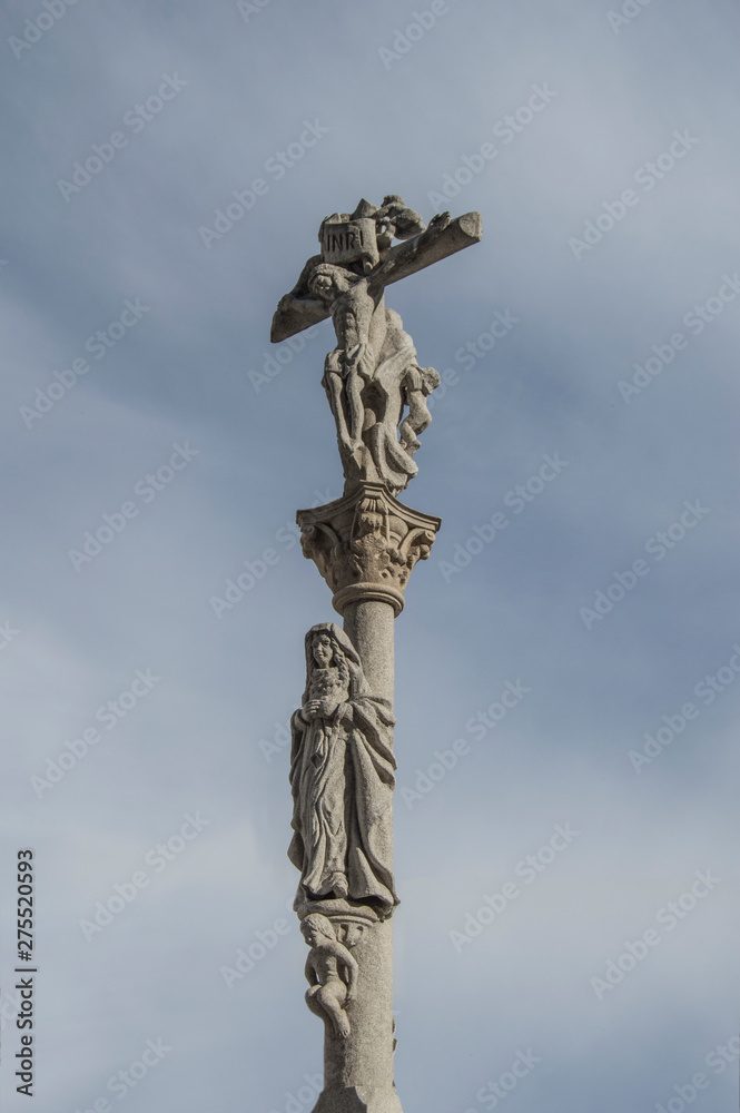 spanish carved stone cross over blue sky in Madrid. Spain