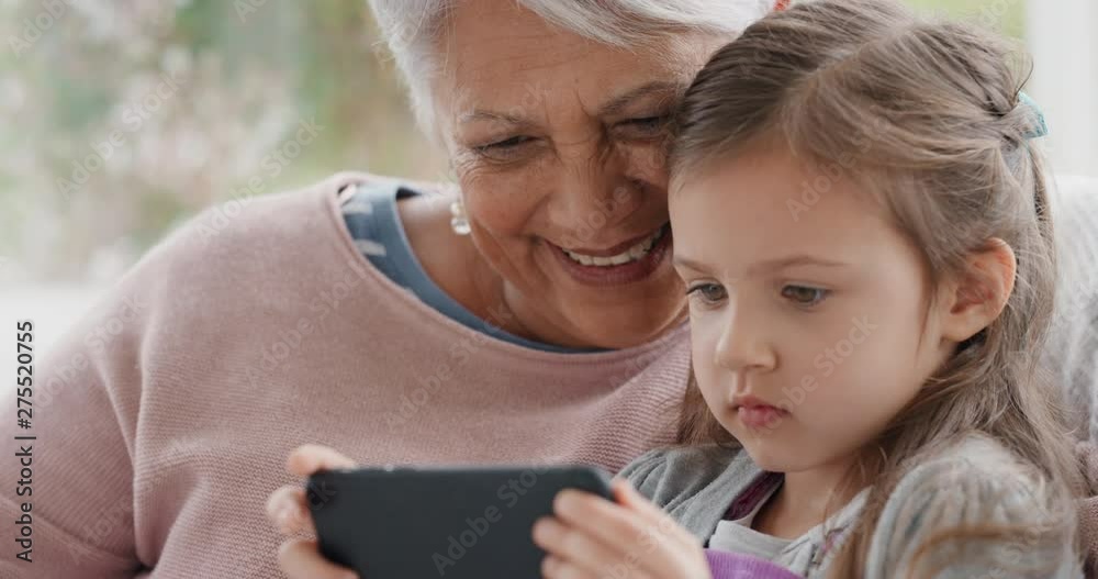little girl showing grandmother how to use smartphone teaching granny ...