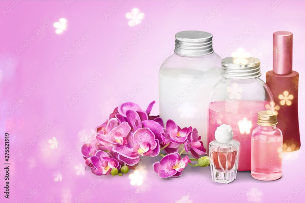 Healthy spa concept with perfume and oil bottles and flowers Healthy spa concept with perfume and oil bottles and flowers