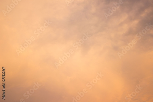 the sky with gentle clouds of pink and orange shade, colored by the setting sun.