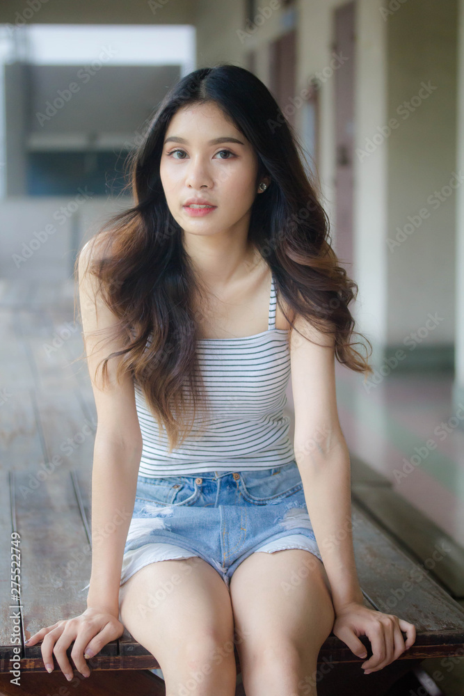 Portrait of thai adult beautiful girl White shirt blue jeans relax time