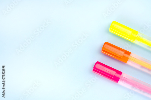 Three neon markers on a blue background.