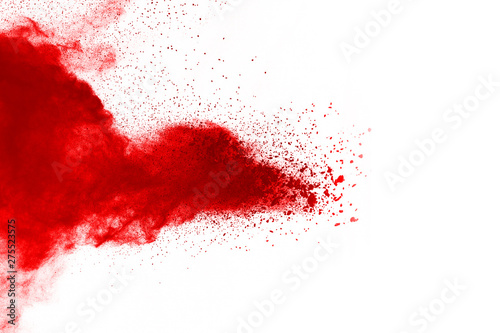 Freeze motion of red powder exploding, isolated on white background. Abstract design of red dust cloud. Particles explosion screen saver, wallpaper