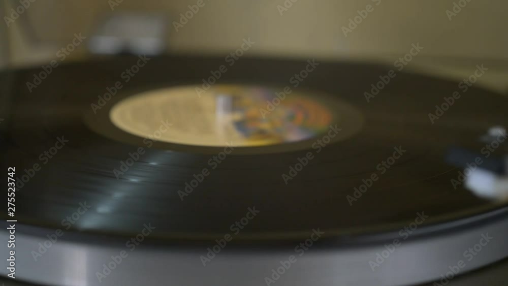 Record being played on a retro turntable that plays vinyl vintage records. Record being played on a retro turntable that plays vinyl vintage records.