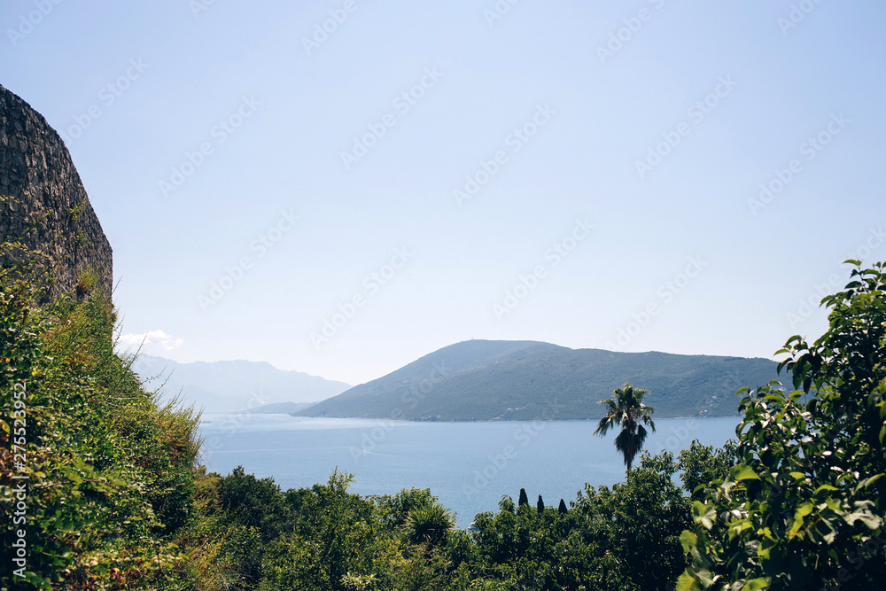 Seascape of the Adriatic Sea. The sea with mountains and mountains in the background. Boat sailing on the sea. Italy, Montenegro, Adriatic tourism