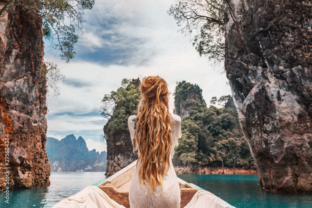 © zolotareva_elina - fashionable young model in boho style dress on boat at the lake