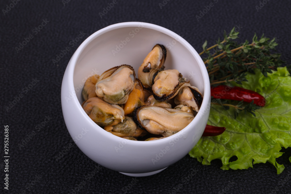 Pickled mussels in the bowl served pepper, garlic and salad Pickled mussels in the bowl served pepper, garlic and salad