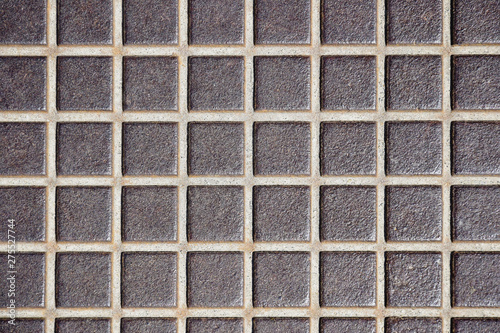 Embossed old metal floor texture, surface in a cage . Rusty metal floor, industrial flooring. Close-up. Selective focus. Copy space.