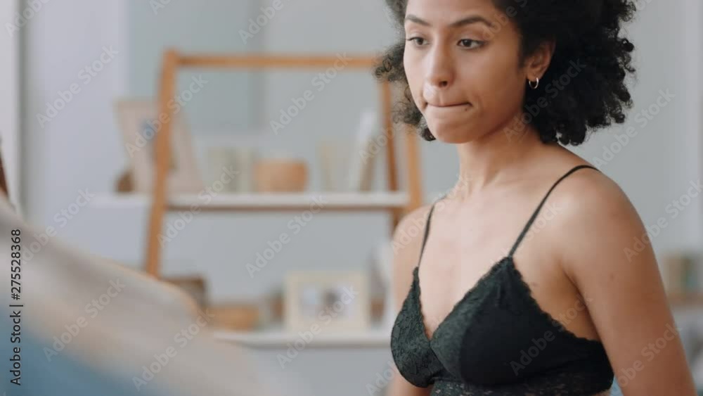 beautiful mixed race woman getting dressed looking in mirror fresh start to new day putting on clothes enjoying morning at home positive self image 4k footage beautiful mixed race woman getting dressed looking in mirror fresh start to new day putting on clothes enjoying morning at home positive self image 4k footage