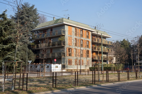 Italy. View of apartment buildings with on the road in the residential area of San Siro, in Milan, early in the morning.