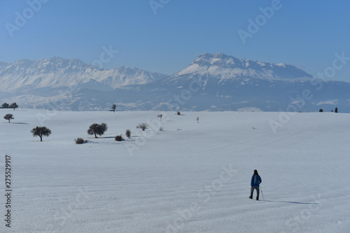 lonely mountaineer hikers on a calm winter day