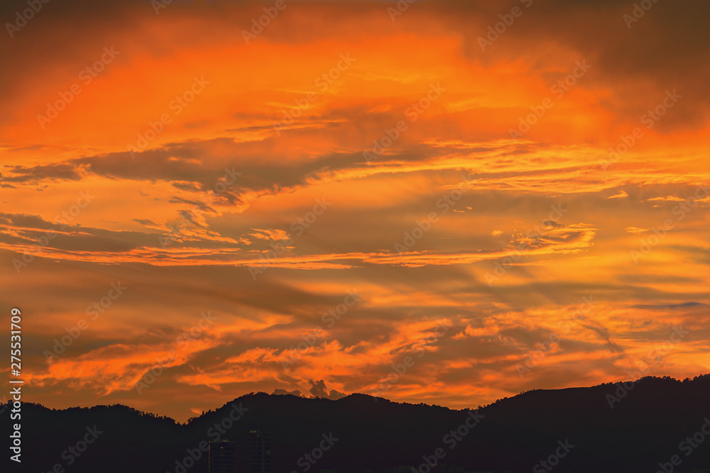 Beautiful colorful sunset clouds over mountains.