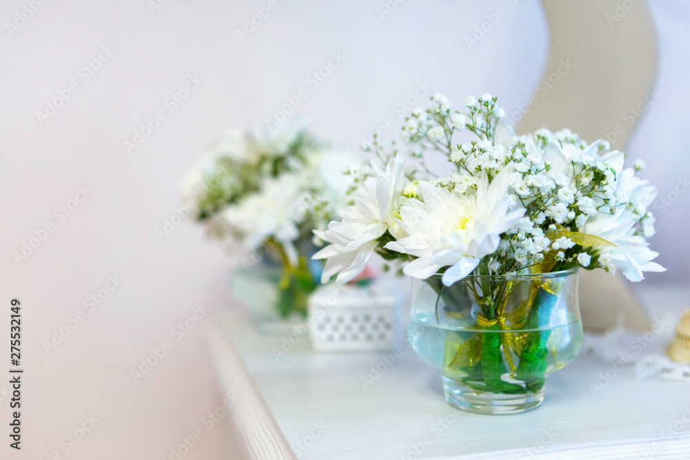 beautiful flowers, white chrysanthemums in weight on the fireplace, places for text