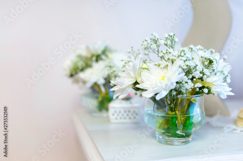 beautiful flowers, white chrysanthemums in weight on the fireplace, places for text