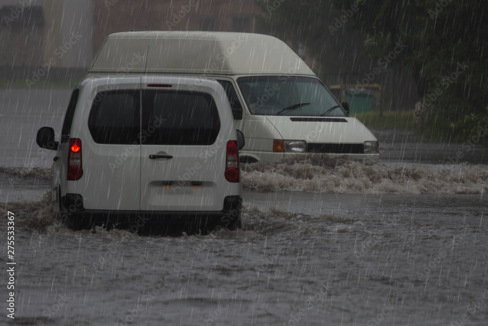 car rides in heavy rain on a flooded road
