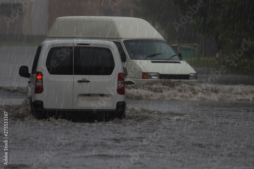 car rides in heavy rain on a flooded road