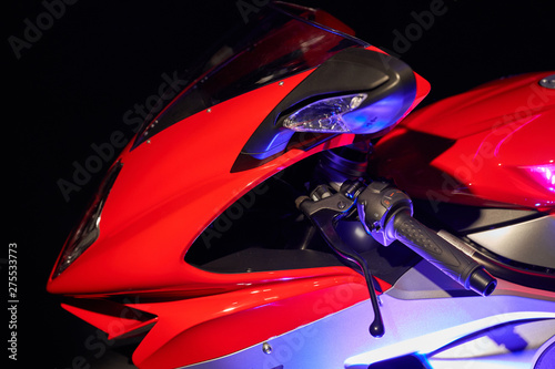 Sportbike on a black background. Front part. Mixed lighting photo