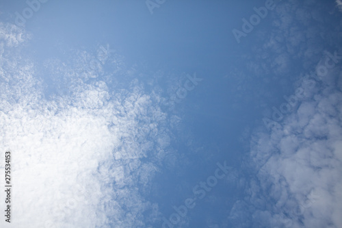 Beautiful view of hight blue sky with clouds. Happiness and freedom. Concept of climate, weather, environment. Background for design. Copy space.