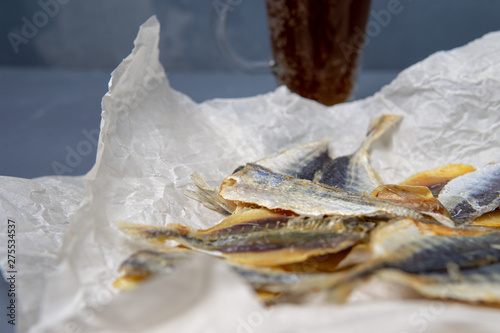 Fototapeta Naklejka Na Ścianę i Meble -  Salted fish lies in unfolded paper.