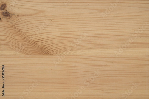 Background made of wood. Glued timber from coniferous woods. One can see the longitudinal filaments and knots.