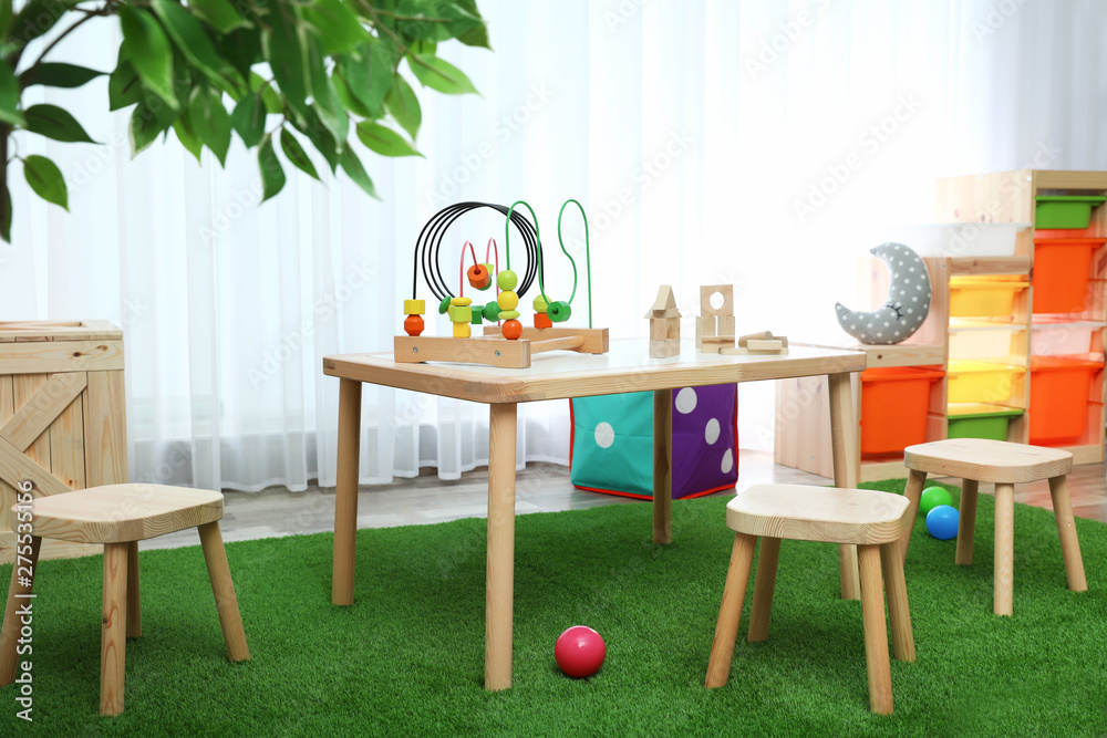 Obraz premium Stylish playroom interior with toys and modern wooden furniture