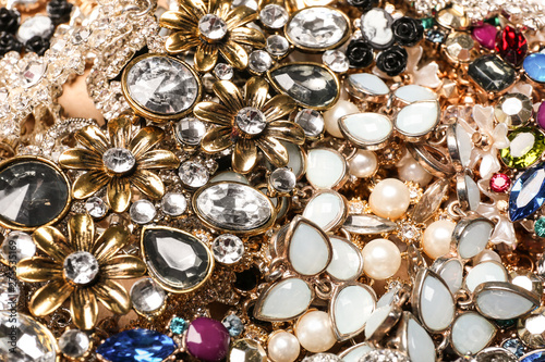 Different stylish jewelry as background  closeup view