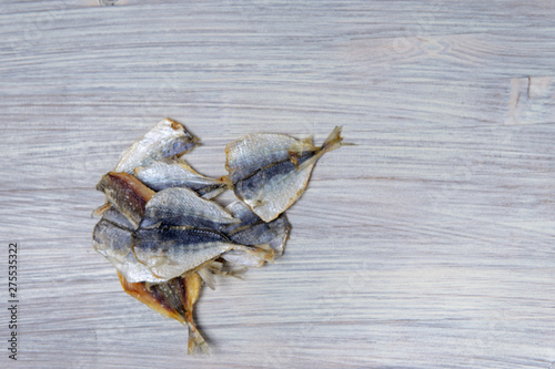 Salted fish lying on a wooden table © Albert Bugaev