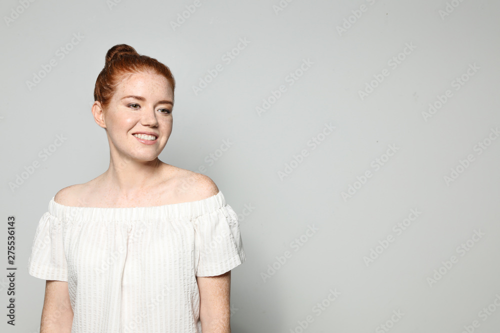 Portrait of young woman with beautiful face on grey background. Space for text Portrait of young woman with beautiful face on grey background. Space for text