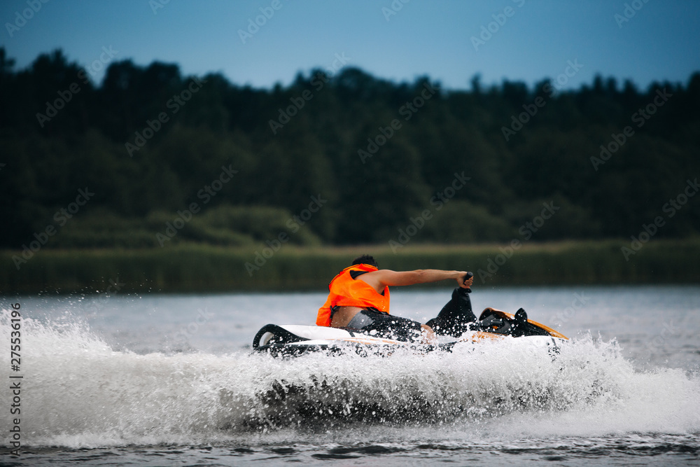 Young man drive a jet ski powerboat