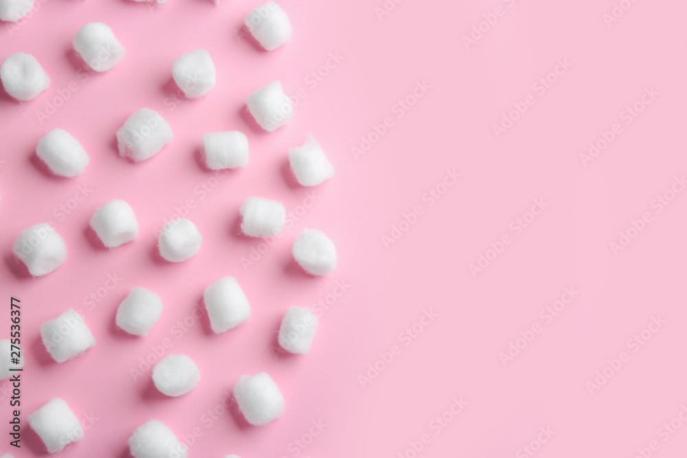 Flat lay composition with cotton balls and space for text on pink background Flat lay composition with cotton balls and space for text on pink background