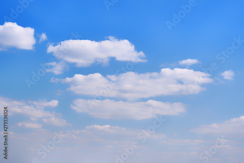 Fototapeta Naklejka Na Ścianę i Meble -  White clouds in clear spring weather. Sunny sky in the morning with floating clouds. Background of cloudy blue sky.