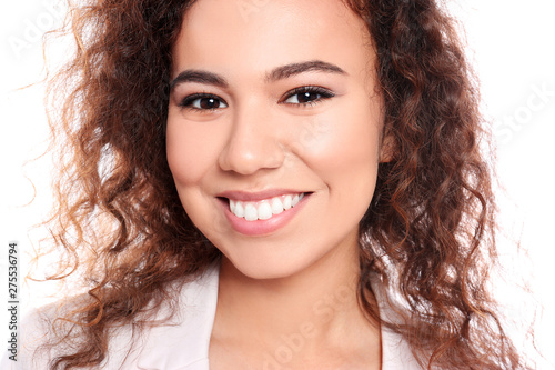 Young African-American woman with beautiful face on white background, closeup