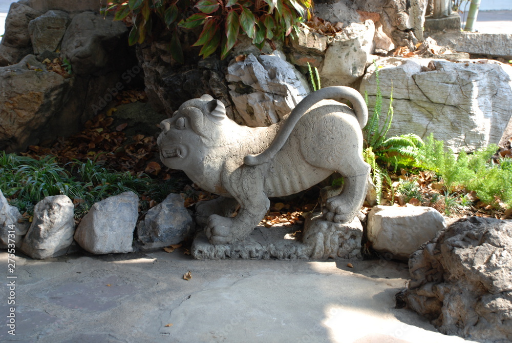 Bangkok, Thailand - 12.25.2012: Stone sculpture of a lion in a buddhist temple