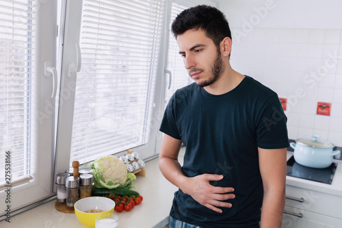 The young man has pain and discomfort in his stomach because he drank milk. He has lactose intolerance.