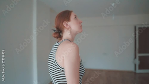 Young homeowner pretty woman is walking on empty house. Attractive girl is renter of house, install design of home. Real estate new agent viewing.