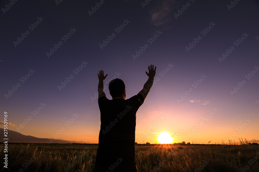 Silhouette man show his hands up Silhouette man show his hands up