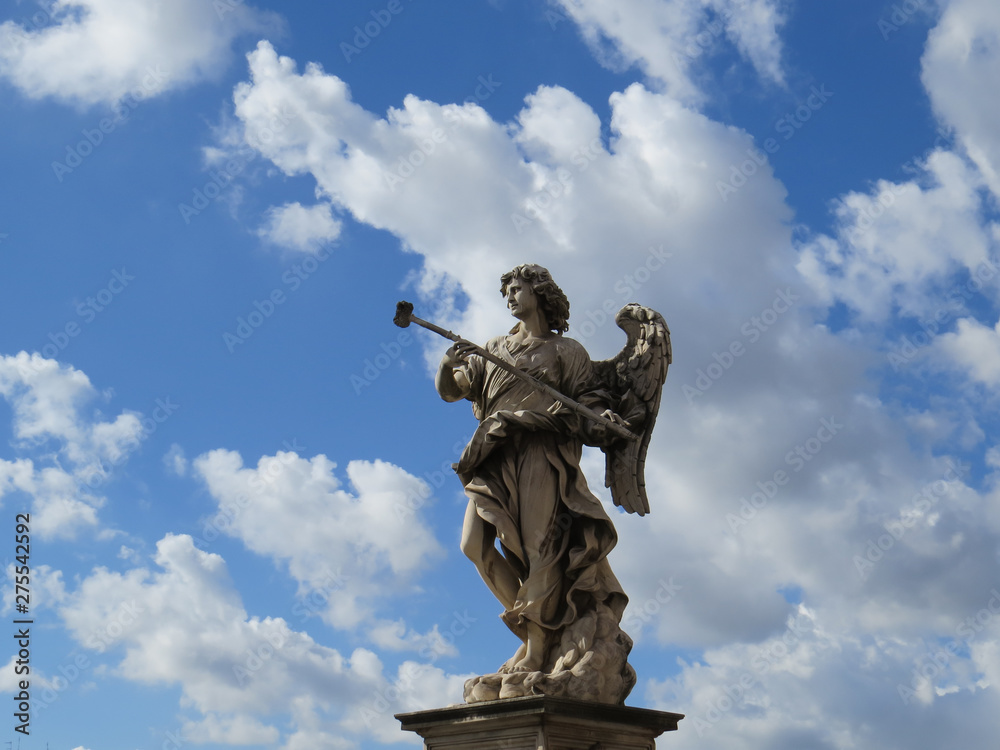 angel statue with blue sky and clouds