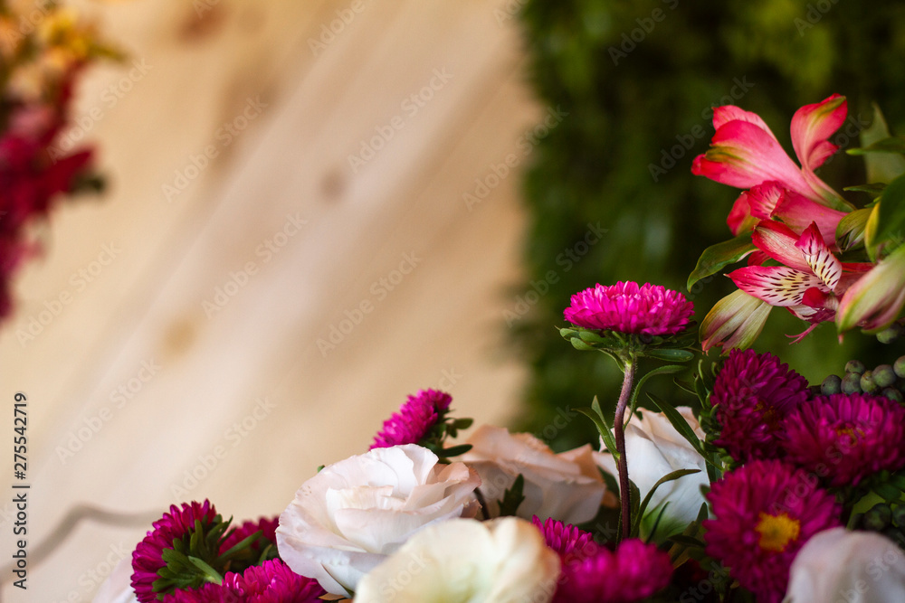 Festive flower composition on the wooden background. Side view with copy space.