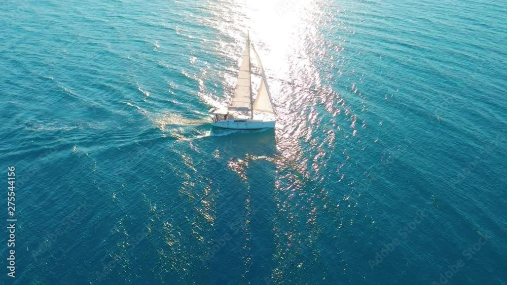 Aerial view. Yacht sailing on open sea at sunny day. Sailing boat in sea.