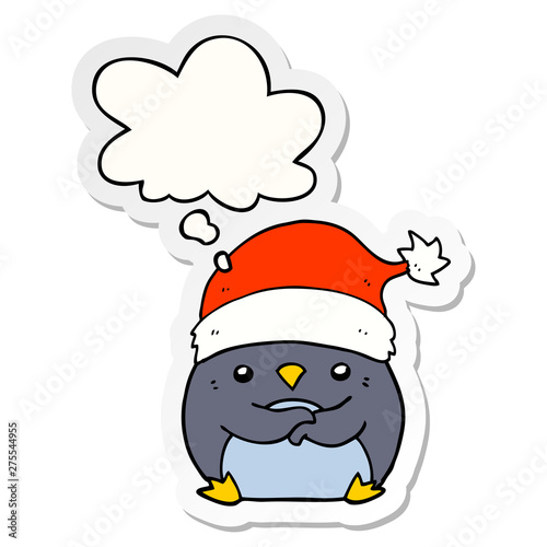 cute cartoon penguin wearing christmas hat and thought bubble as a printed sticker