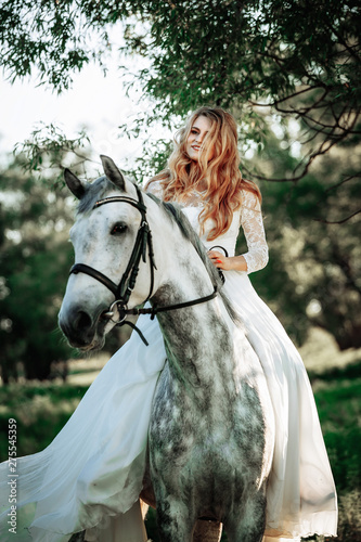 Beautiful and stunning bride, riding a horse in the nature © matilda553