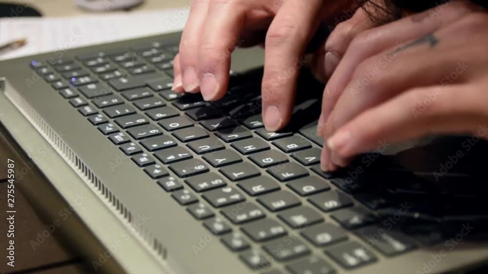 Woman typing in her laptop while working in her home Woman typing in her laptop while working in her home