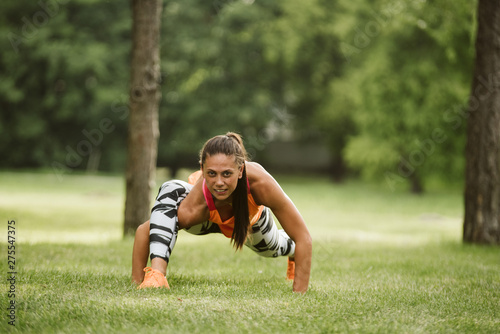  A beautiful fitness girl trains in the park © Dragica