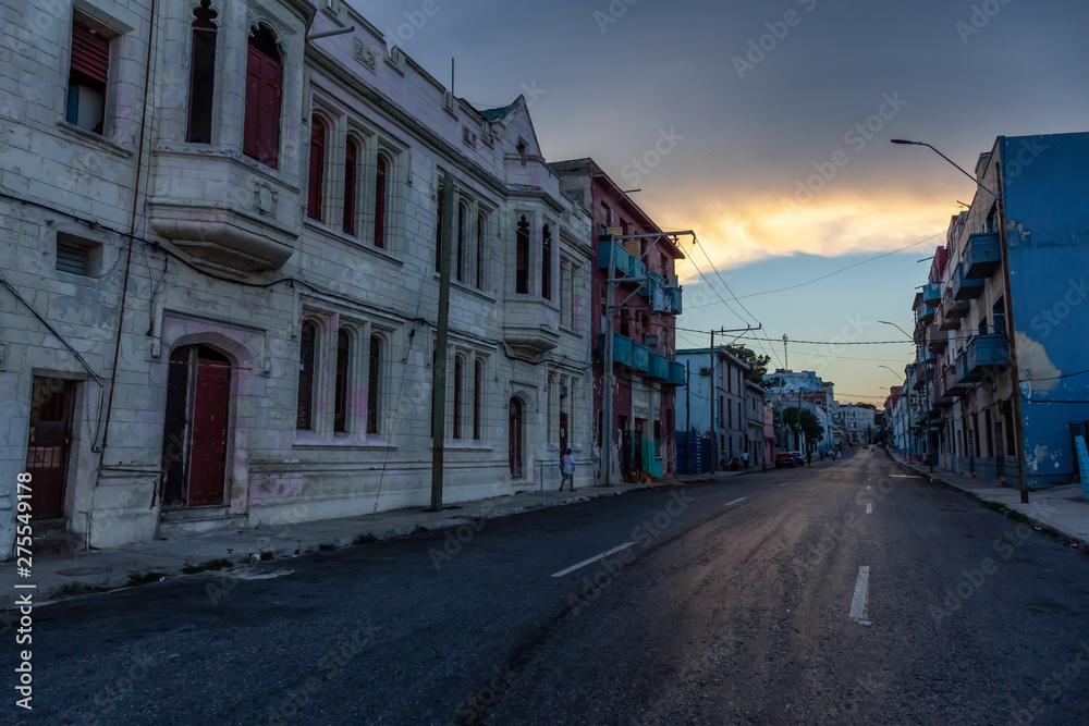 Street View of the Old Havana City, Capital of Cuba, during a cloudy and sunny sunset.