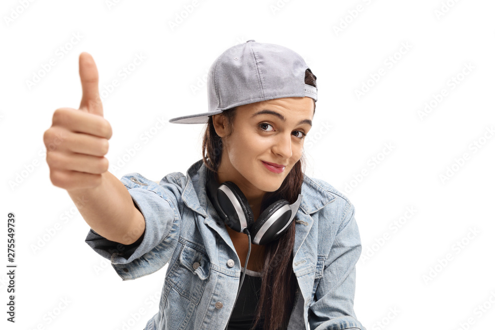 Female with headphones making a thumb up sign Female with headphones making a thumb up sign