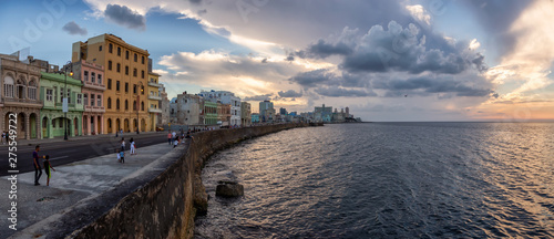 Panoramic view of the Old Havana City, Capital of Cuba, by the ocean coast during a dramatic cloudy sunset. photo