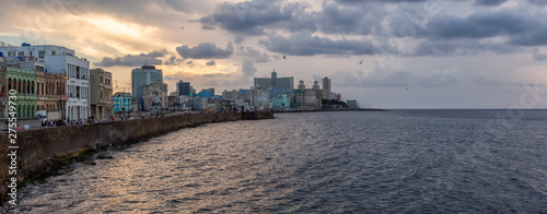 Panoramic view of the Old Havana City, Capital of Cuba, by the ocean coast during a dramatic cloudy sunset. © edb3_16