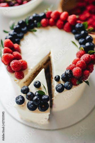 Close up. Creamy mascarpone cheese cake with strawberry and winter berries. New York Cheesecake. Close up. Christmas dessert. Healthy food. Creative atmospheric decoration.