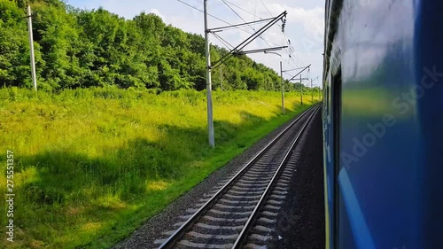 The passenger train returns to the right. The view from the window of the car, bus, train. Journey from the train on a sunny day photo